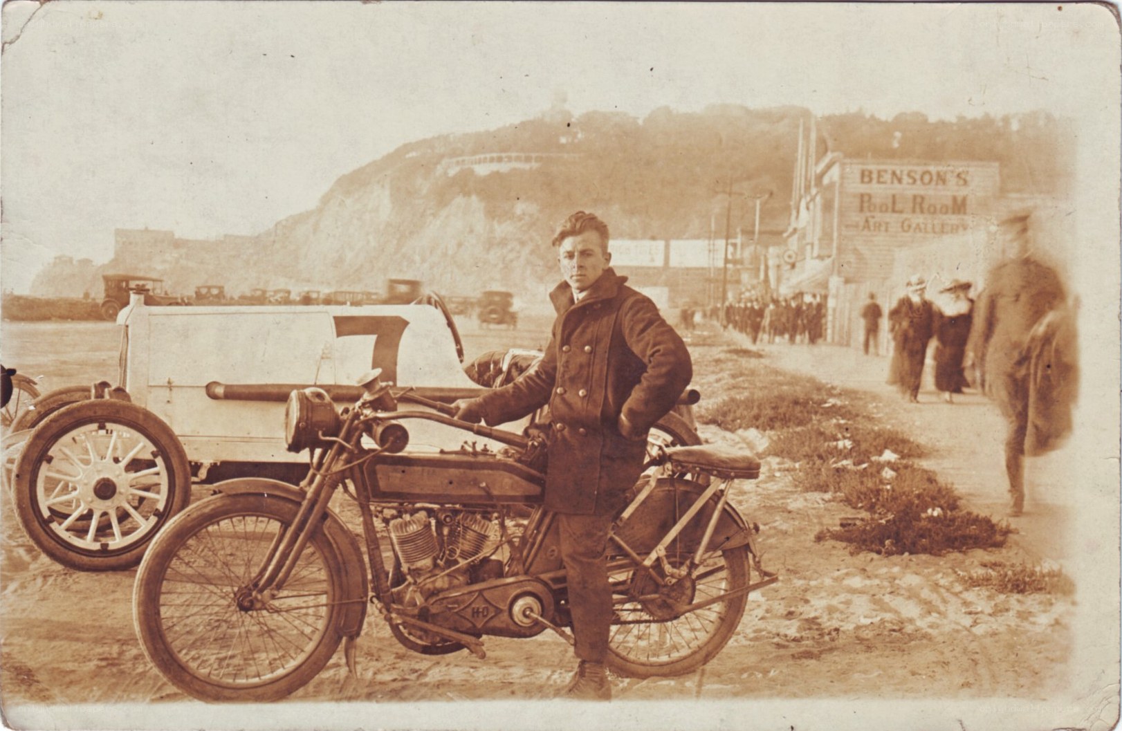 Man with motorcycle and car