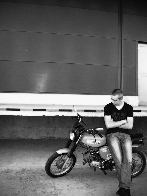 Man with motorcycle in black and white