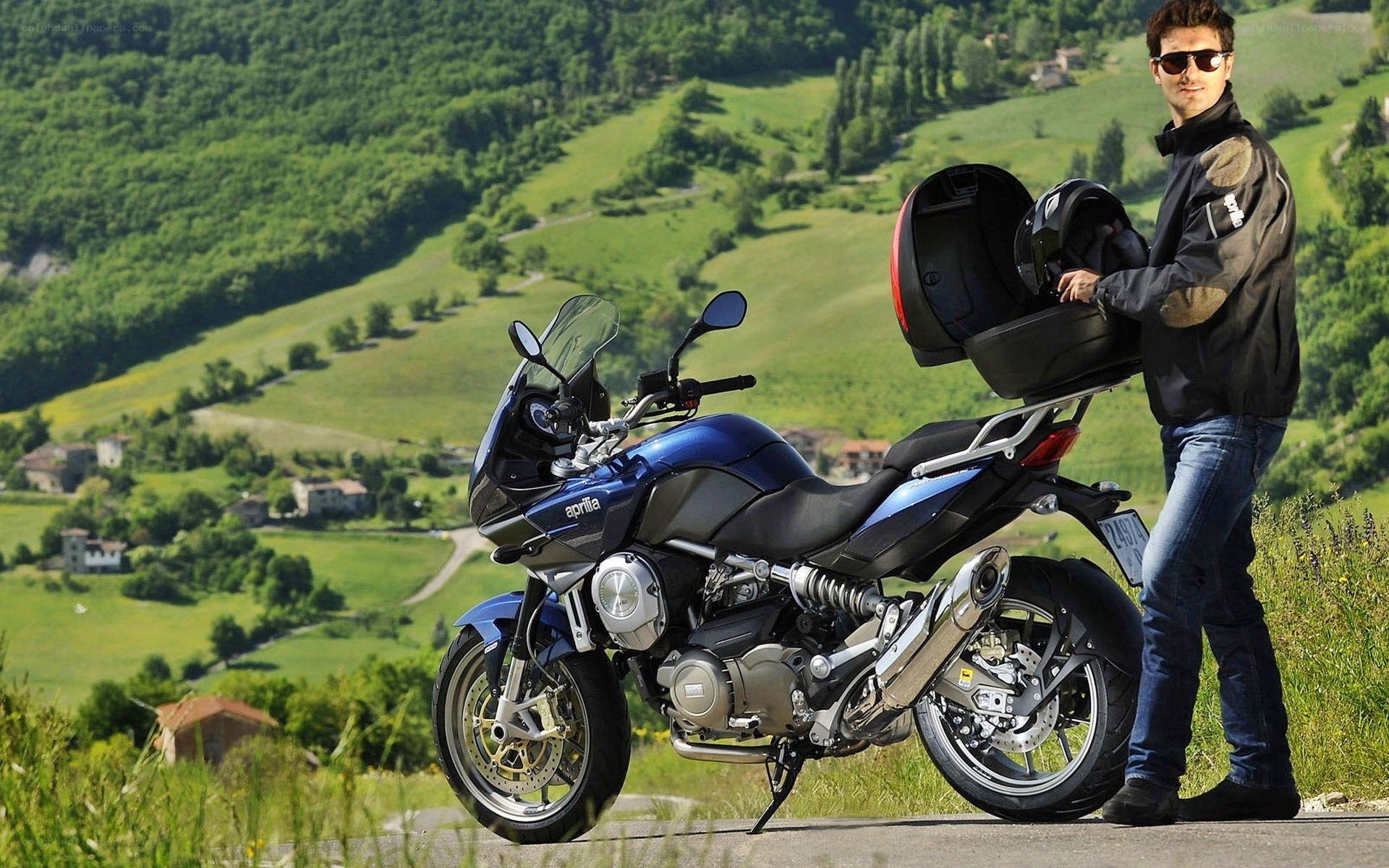 Man with motorcycle in countryside