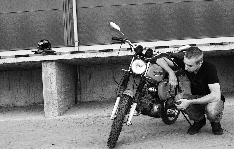 man with motorcycle in garage