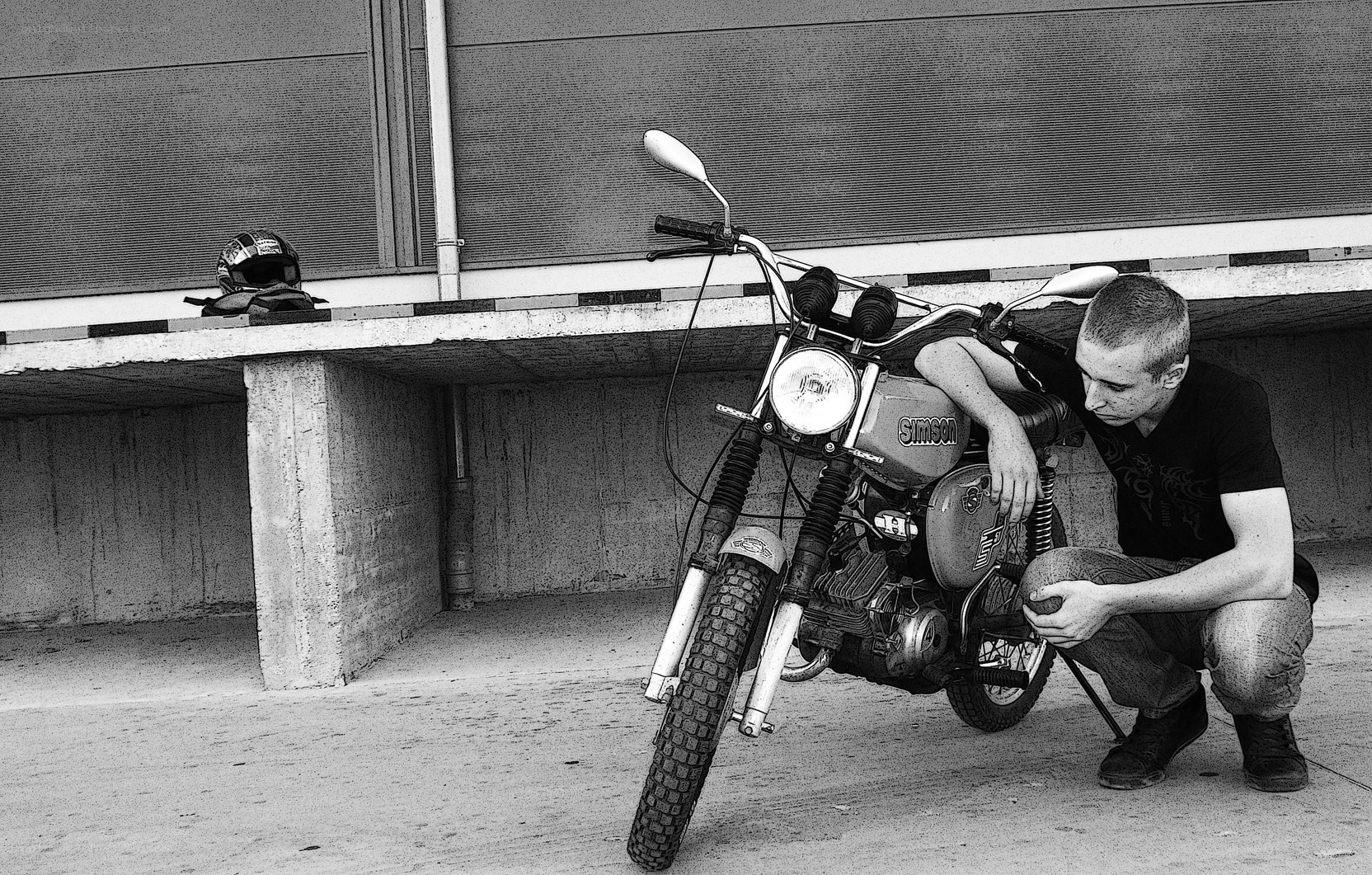 man with motorcycle in garage
