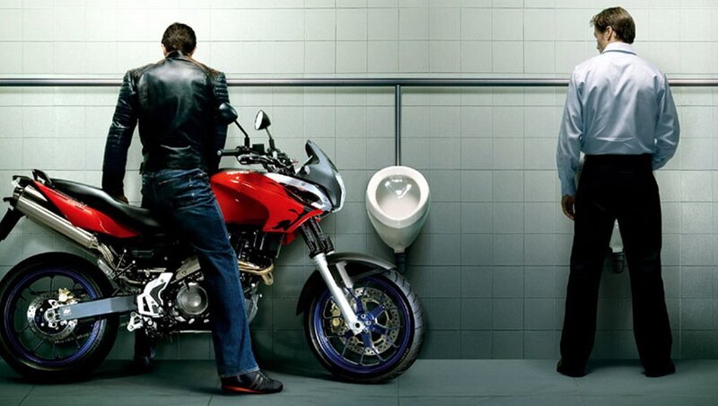 Man with motorcycle in restroom