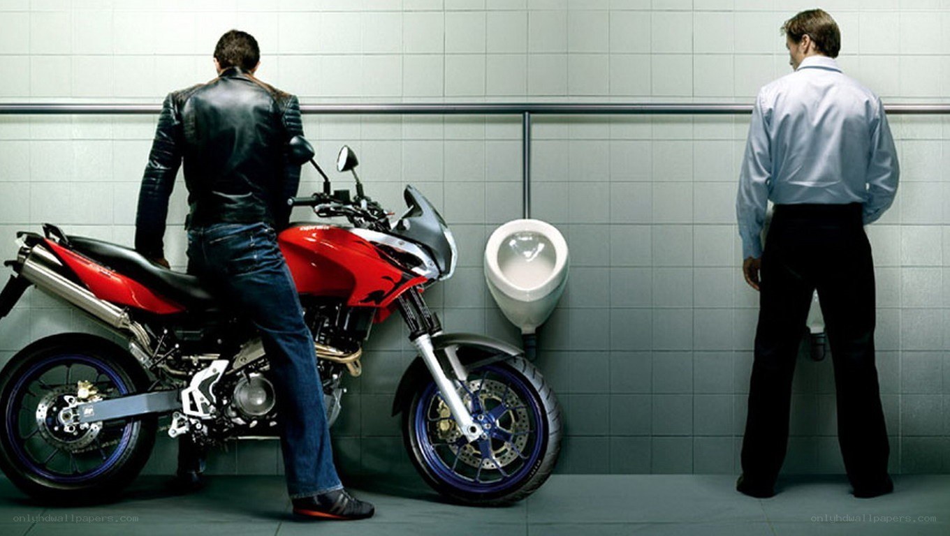 Man with motorcycle in restroom