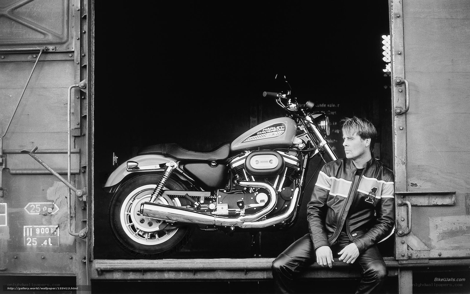 Man with motorcycle in trailer