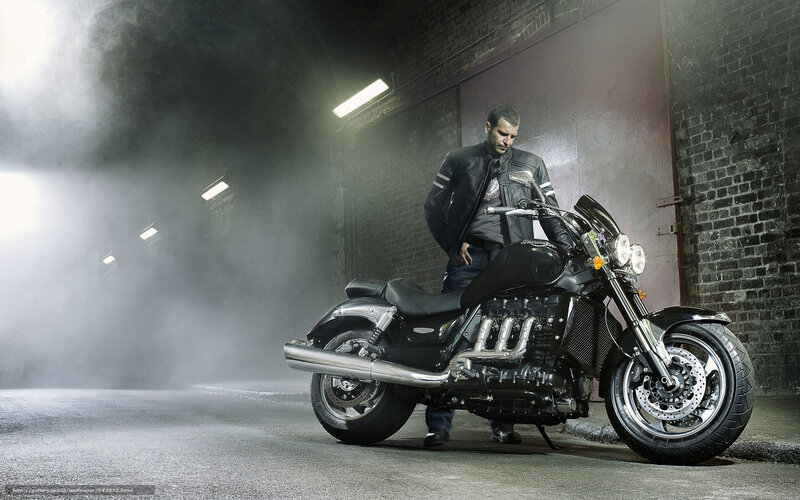 Man with motorcycle in tunnel