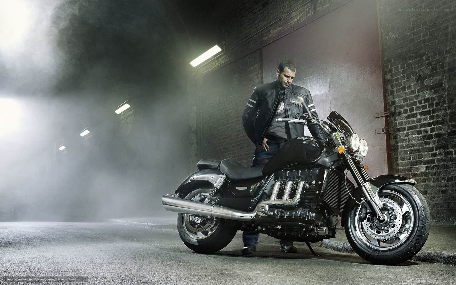 Man with motorcycle in tunnel