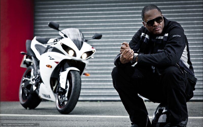Man with motorcycle in urban setting