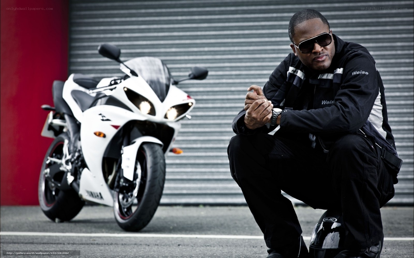Man with motorcycle in urban setting