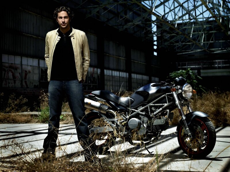 man with motorcycle in warehouse