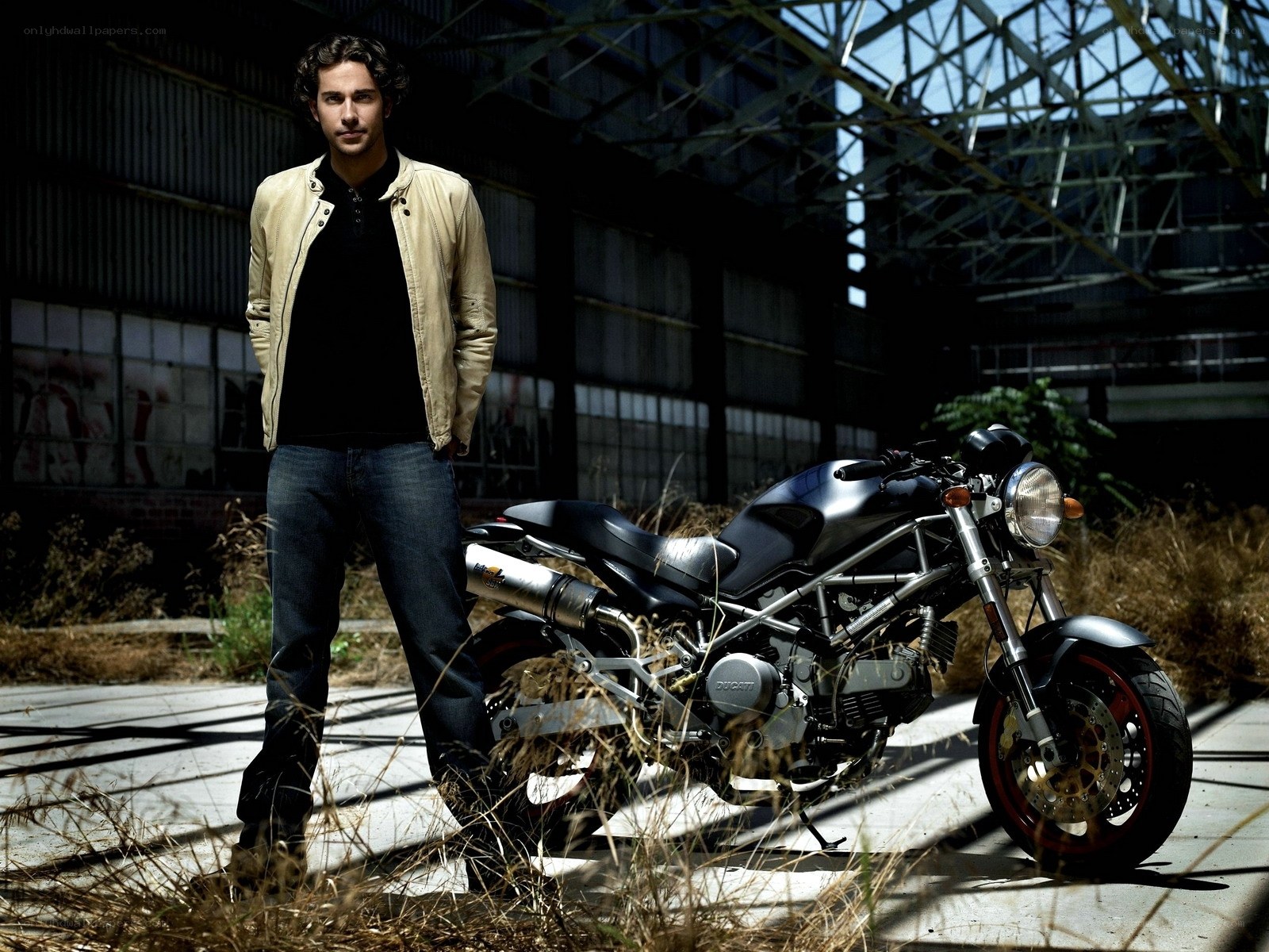 man with motorcycle in warehouse