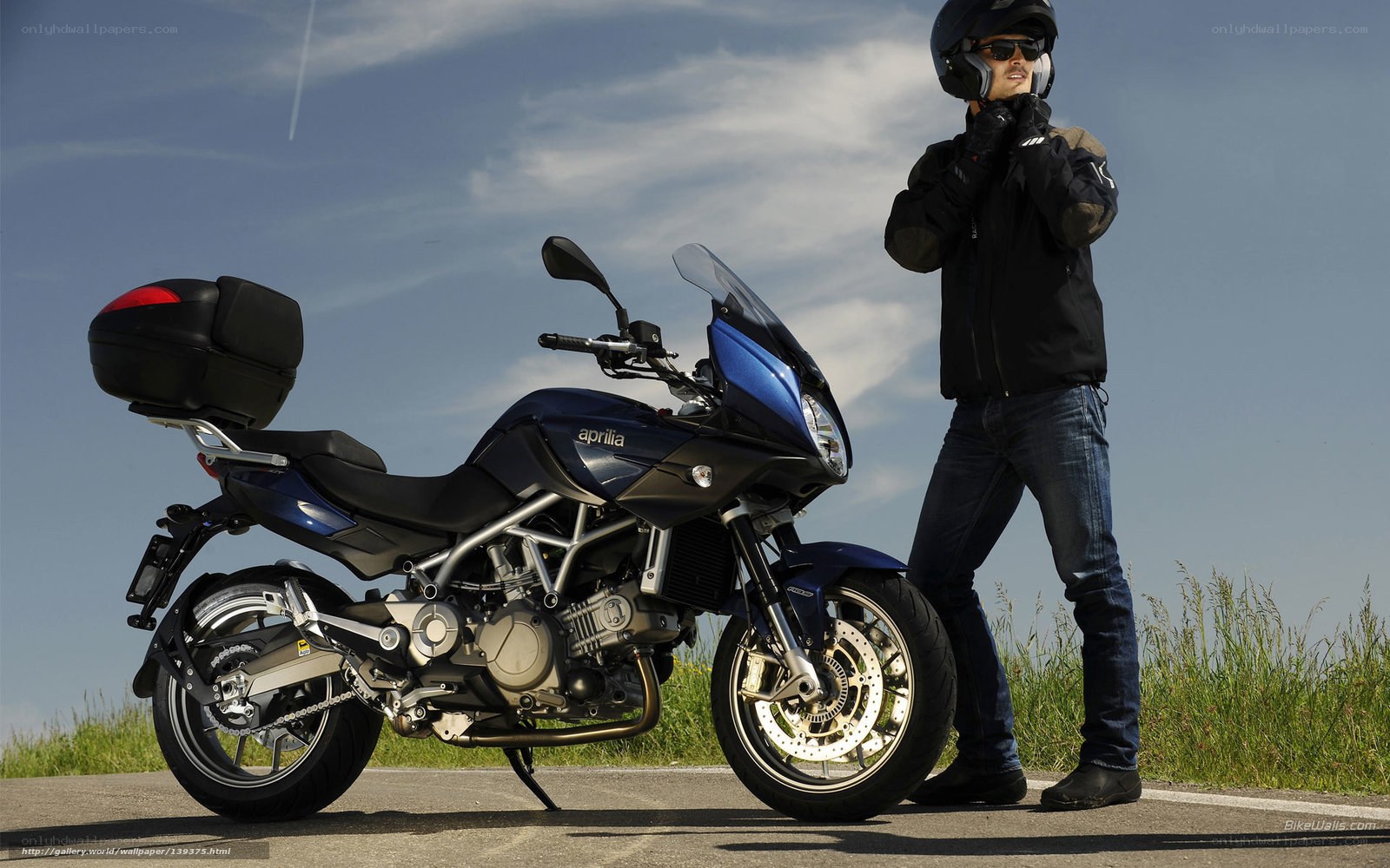 Man with motorcycle on road