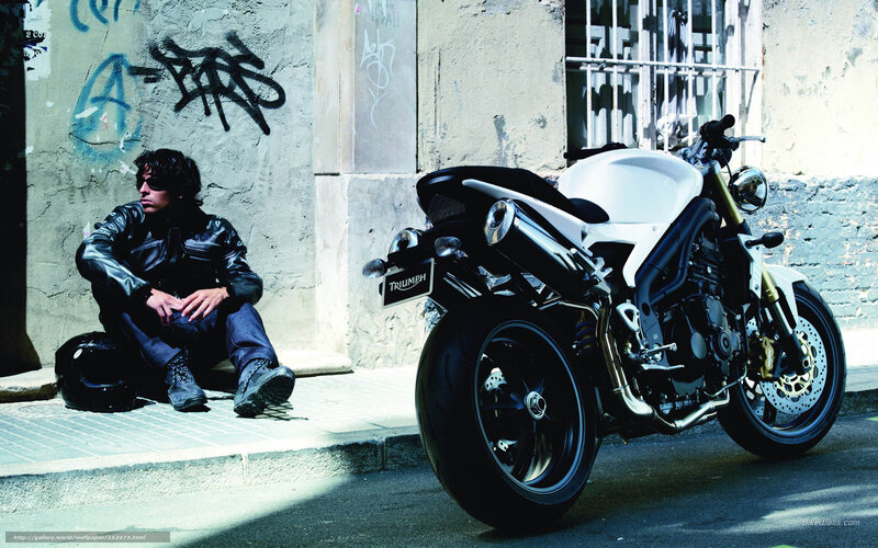 Man with motorcycle on street