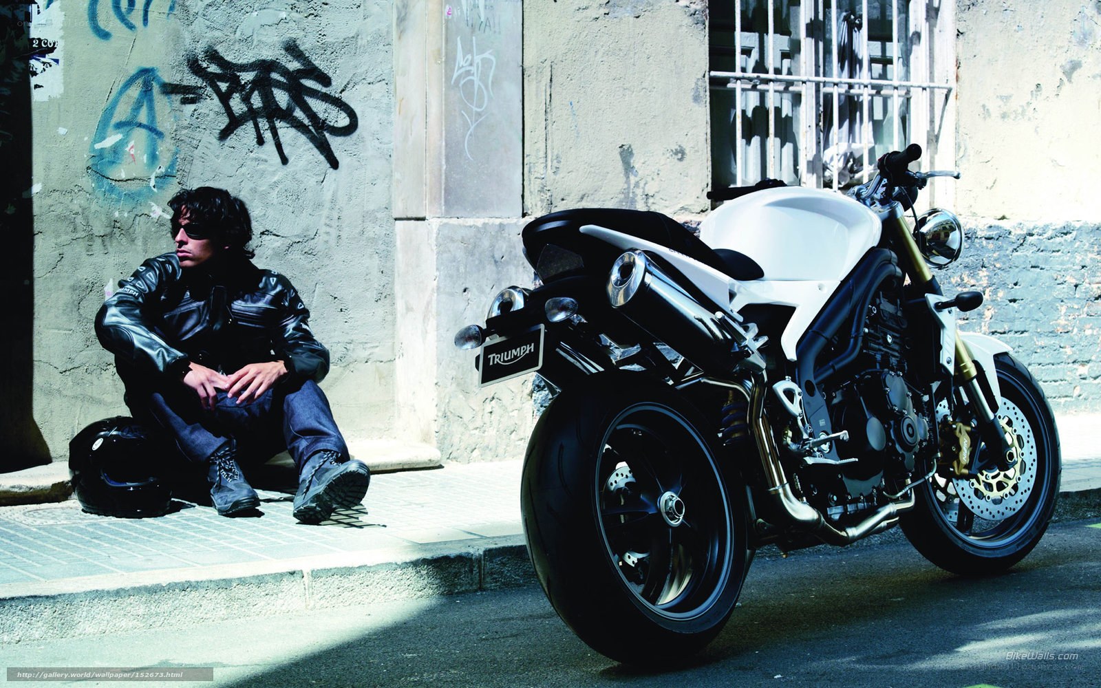 Man with motorcycle on street