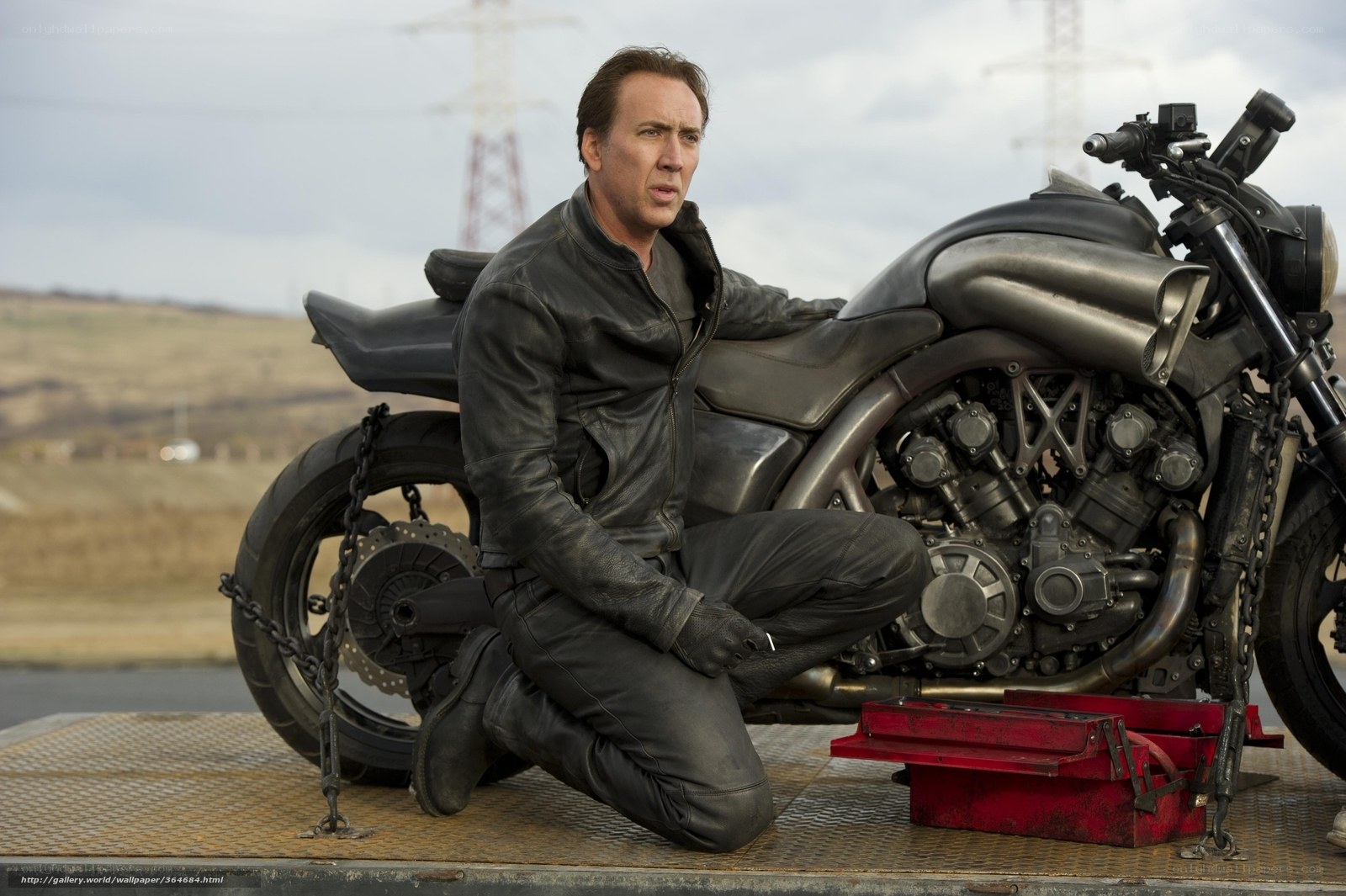 man with motorcycle on trailer
