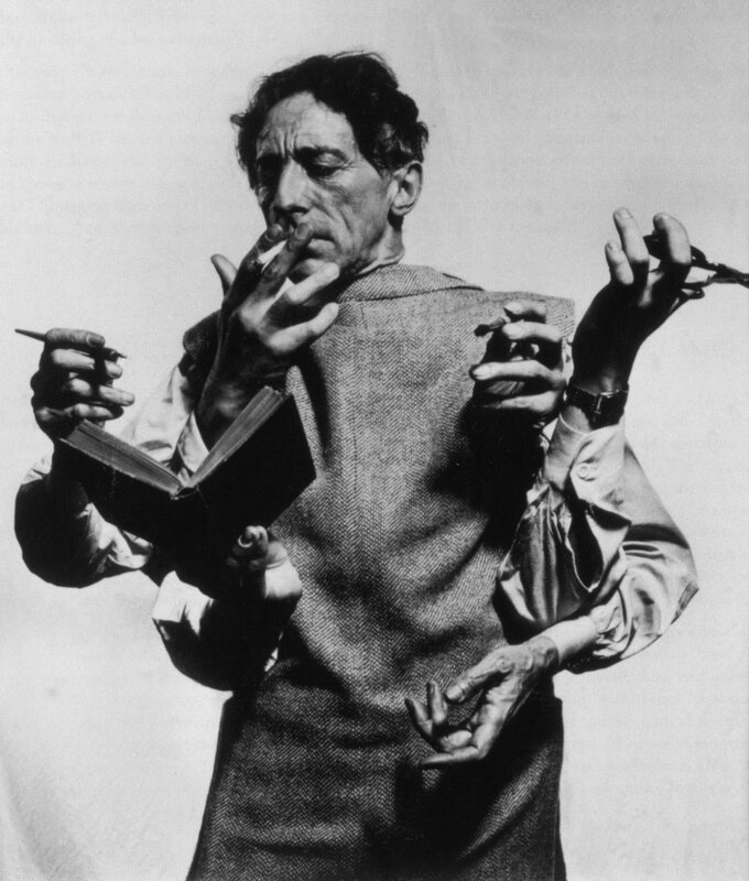 Man with multiple hands holding objects