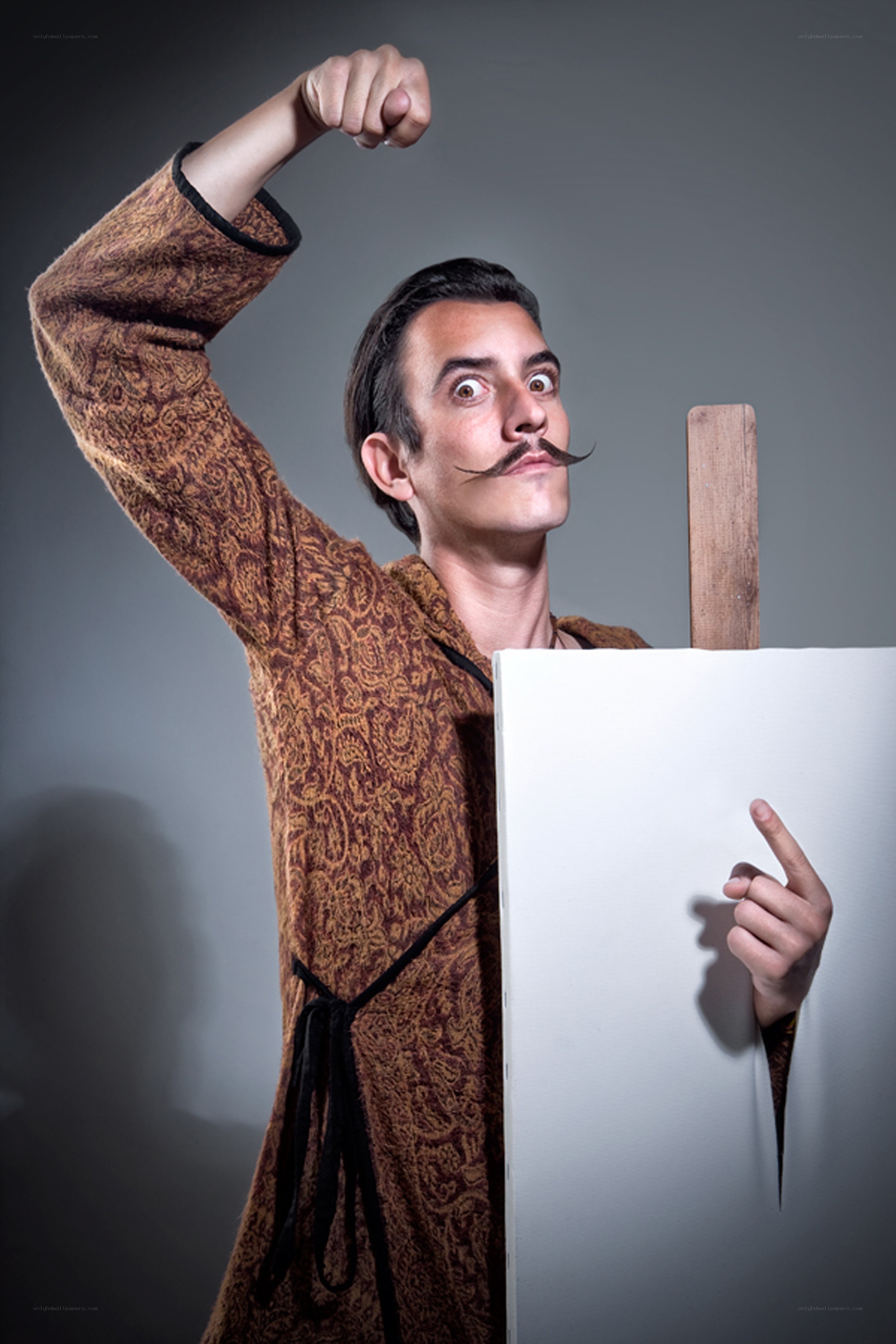 man with mustache and canvas