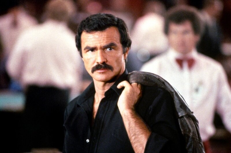 Man with Mustache Holding Jacket