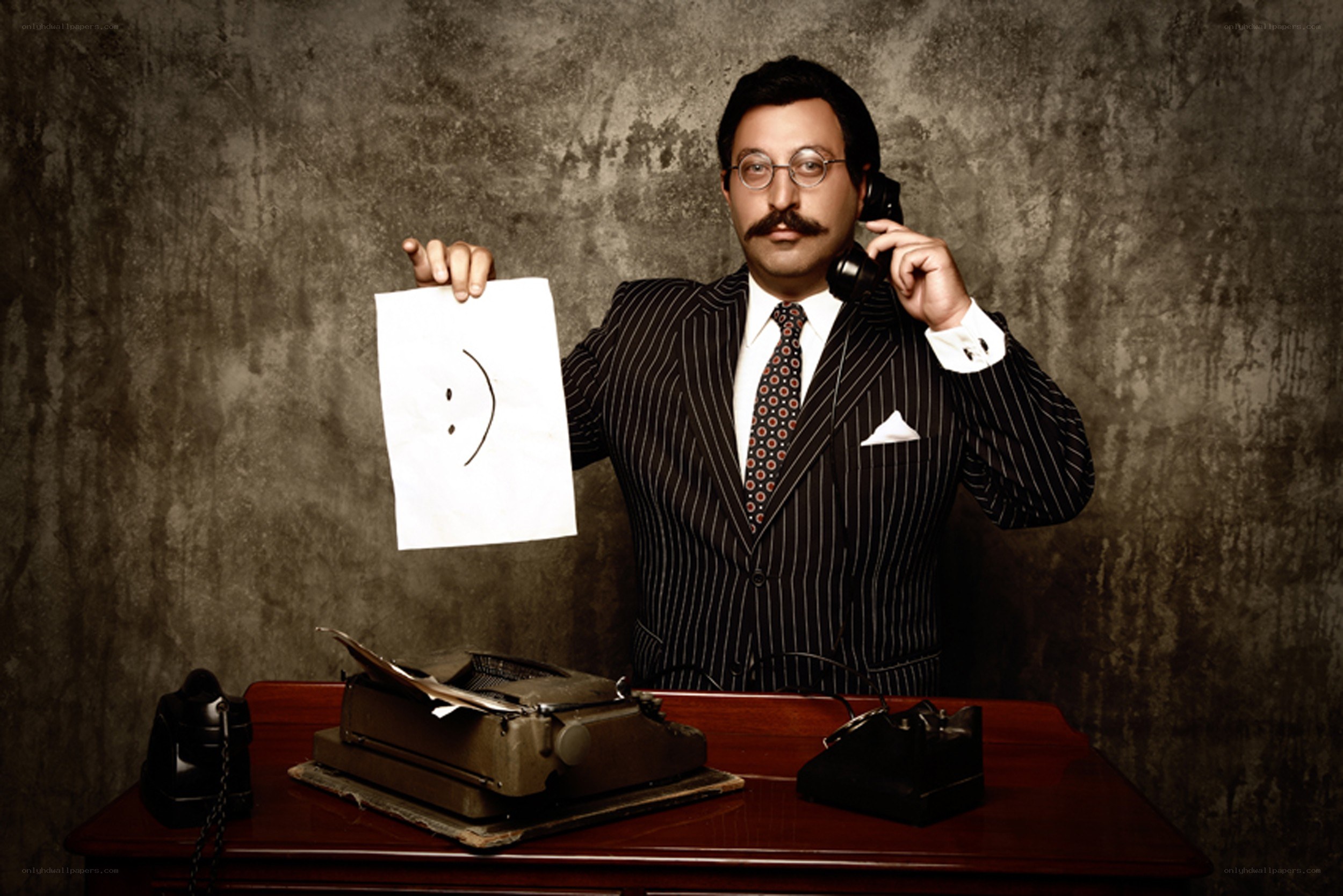 Man with mustache holding paper
