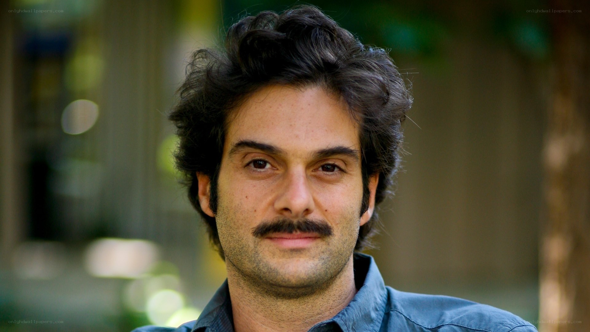man with mustache in blue shirt