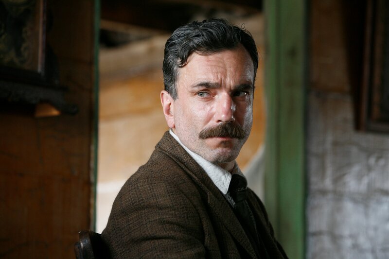 man with mustache in brown jacket