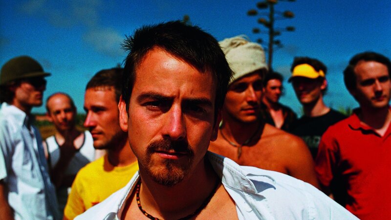man with mustache in crowd