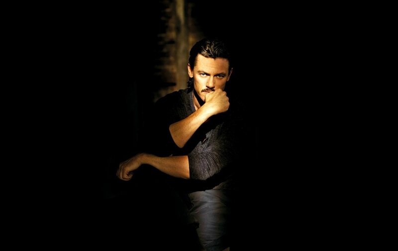Man with Mustache in Dark Room