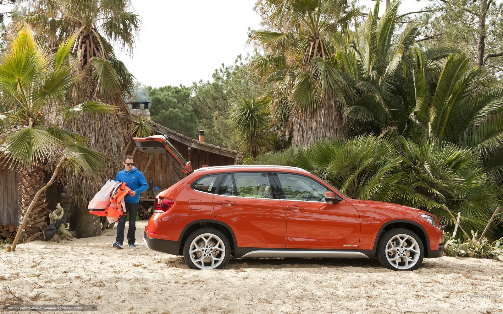 Man with orange car on beach