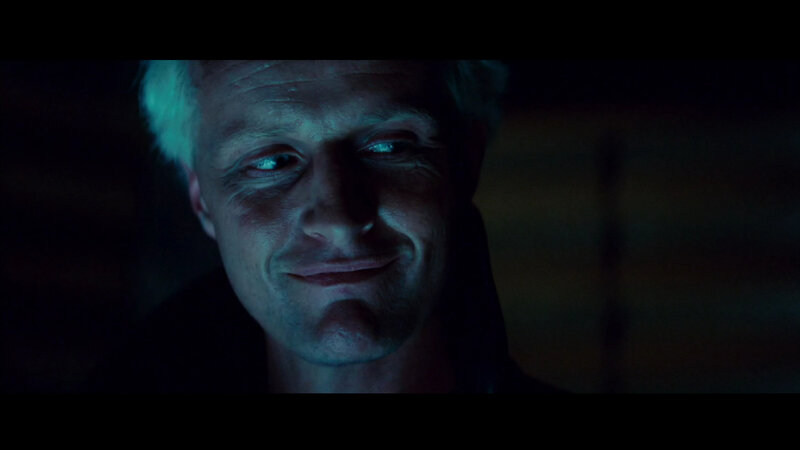 man with pale hair in dark room