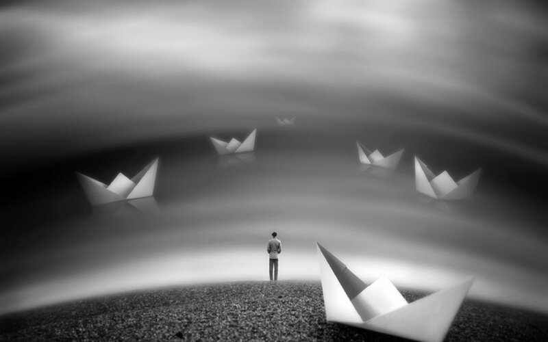 man with paper boats