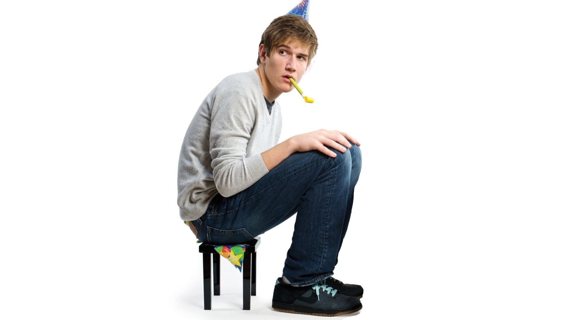 man with party hat and noisemaker