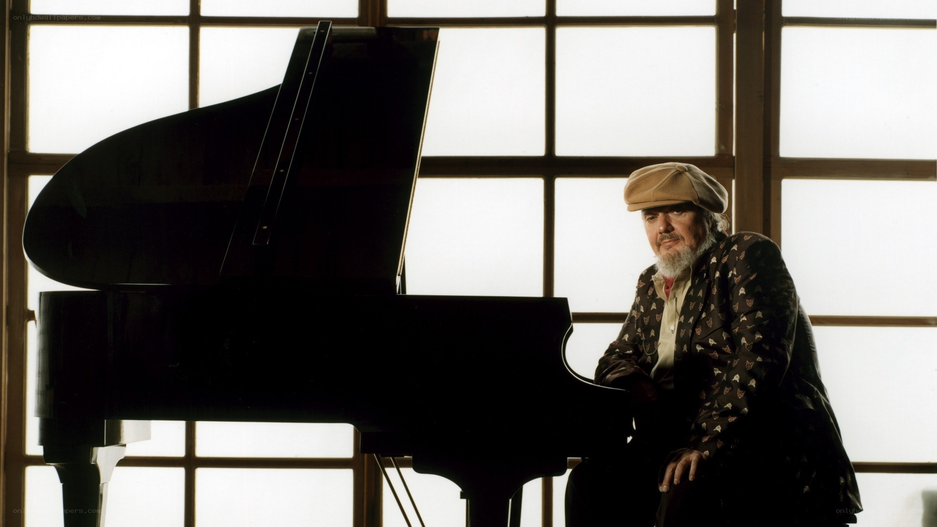 man with piano by window