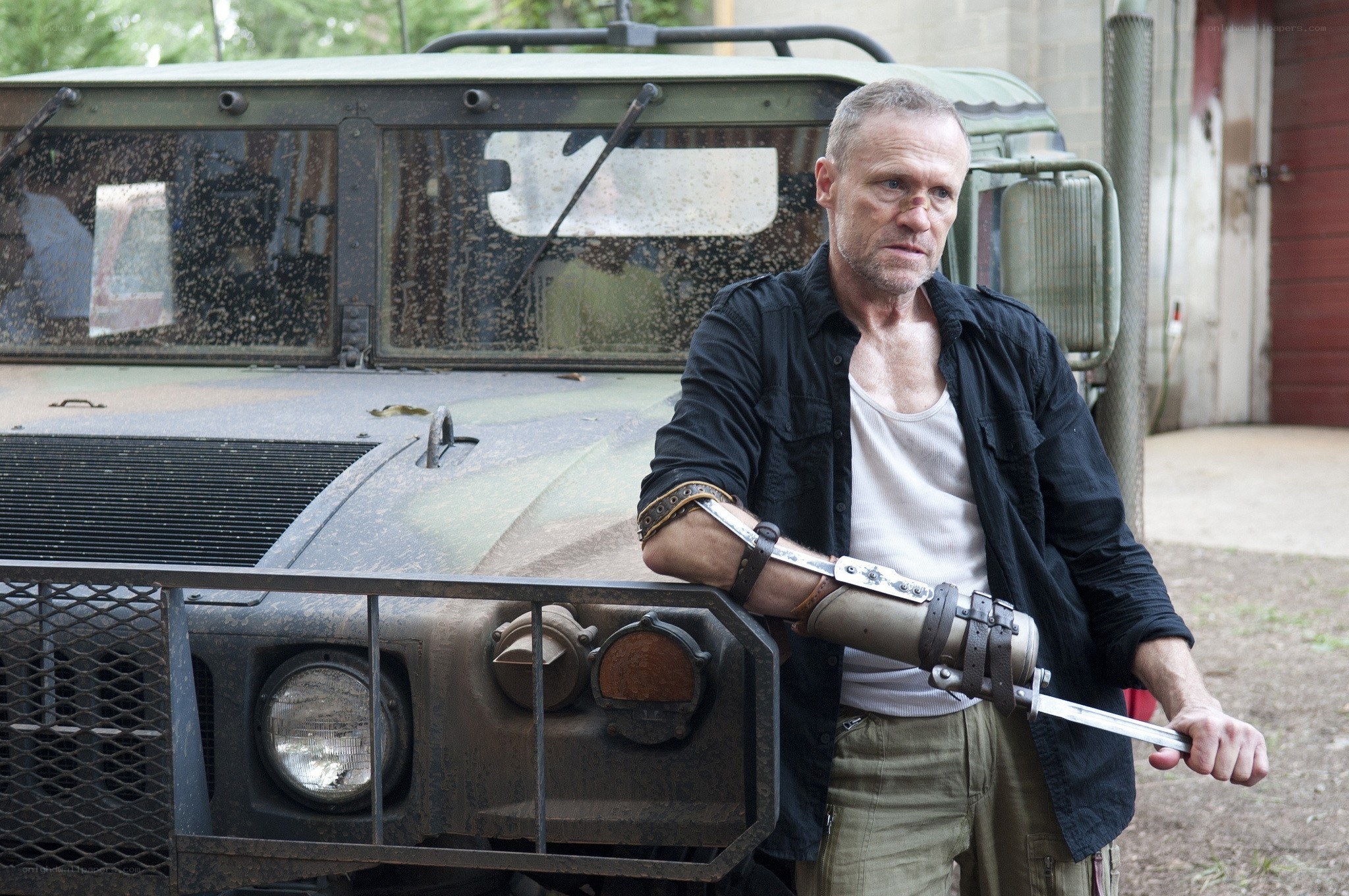 man with prosthetic arm holding knife