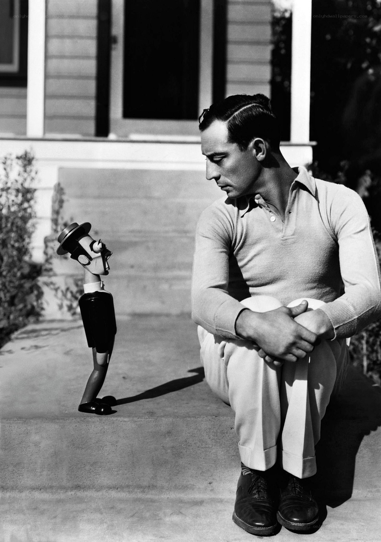 Man with puppet on porch