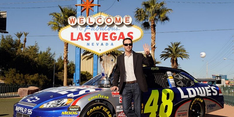 Man with race car at Las Vegas sign