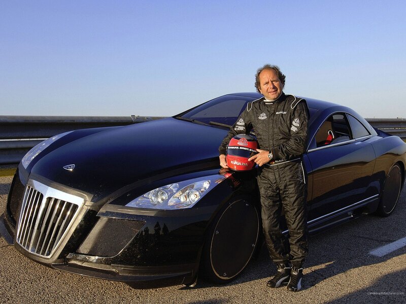 Man with racing helmet and luxury car