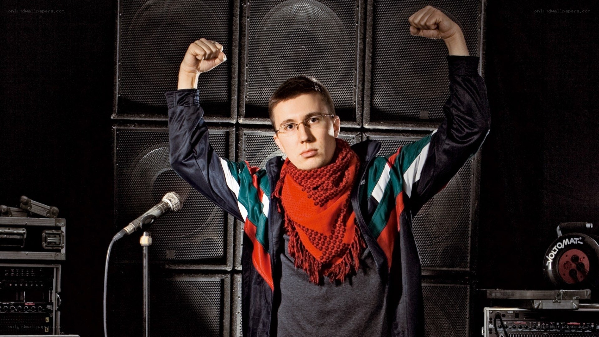 man with raised fists on stage