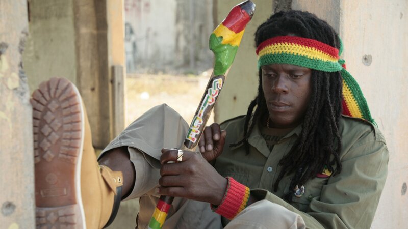 man with rasta stick