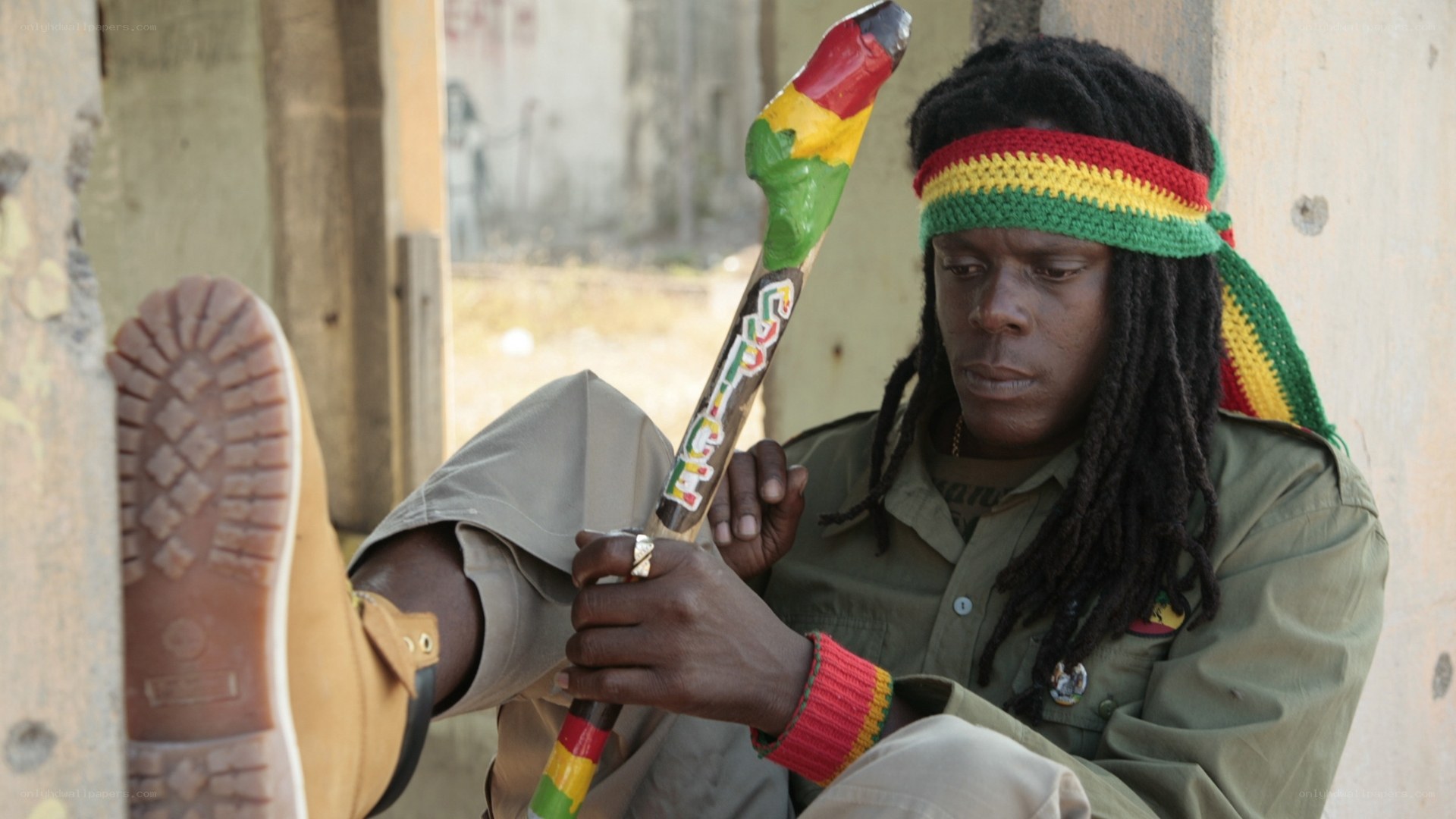 man with rasta stick