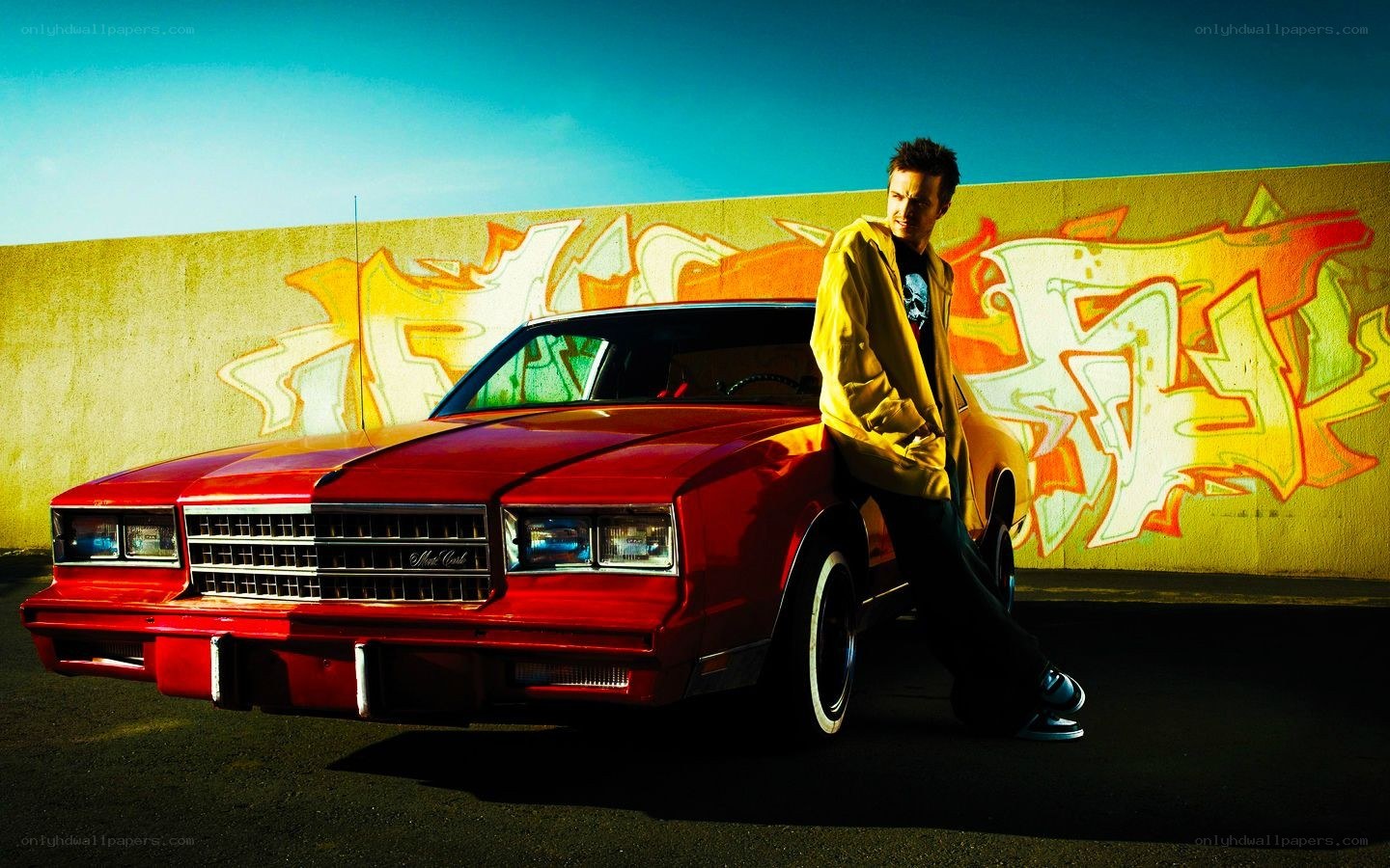 man with red car and graffiti