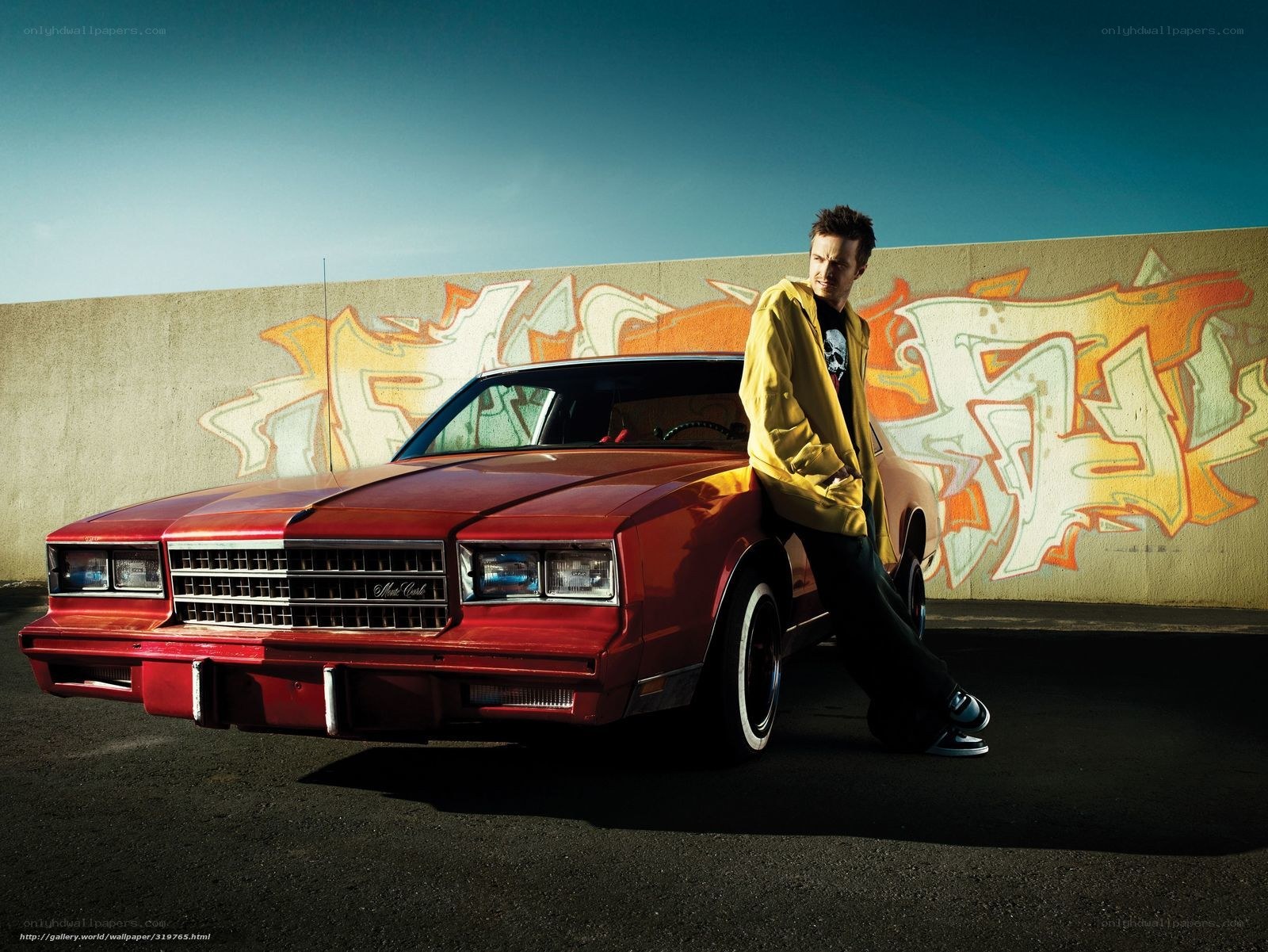 Man with red car and graffiti