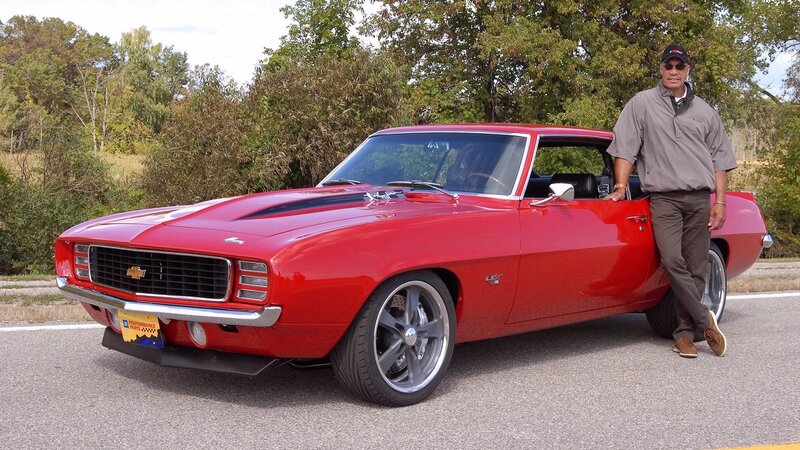 Man with red classic car