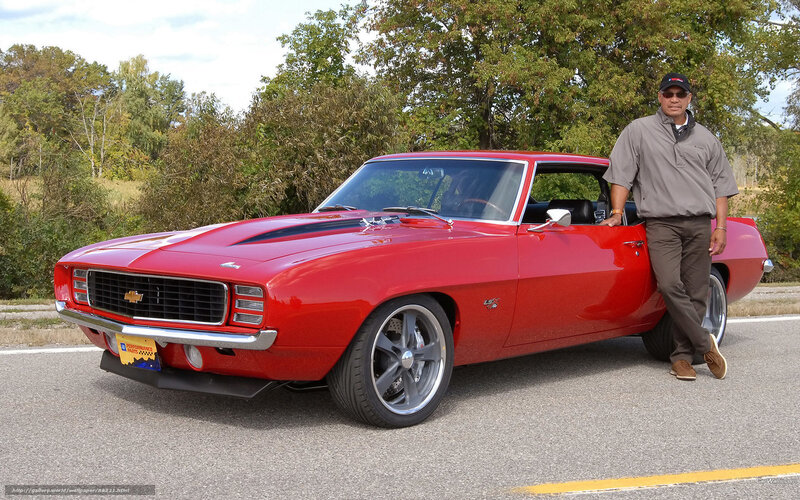 Man with red classic car