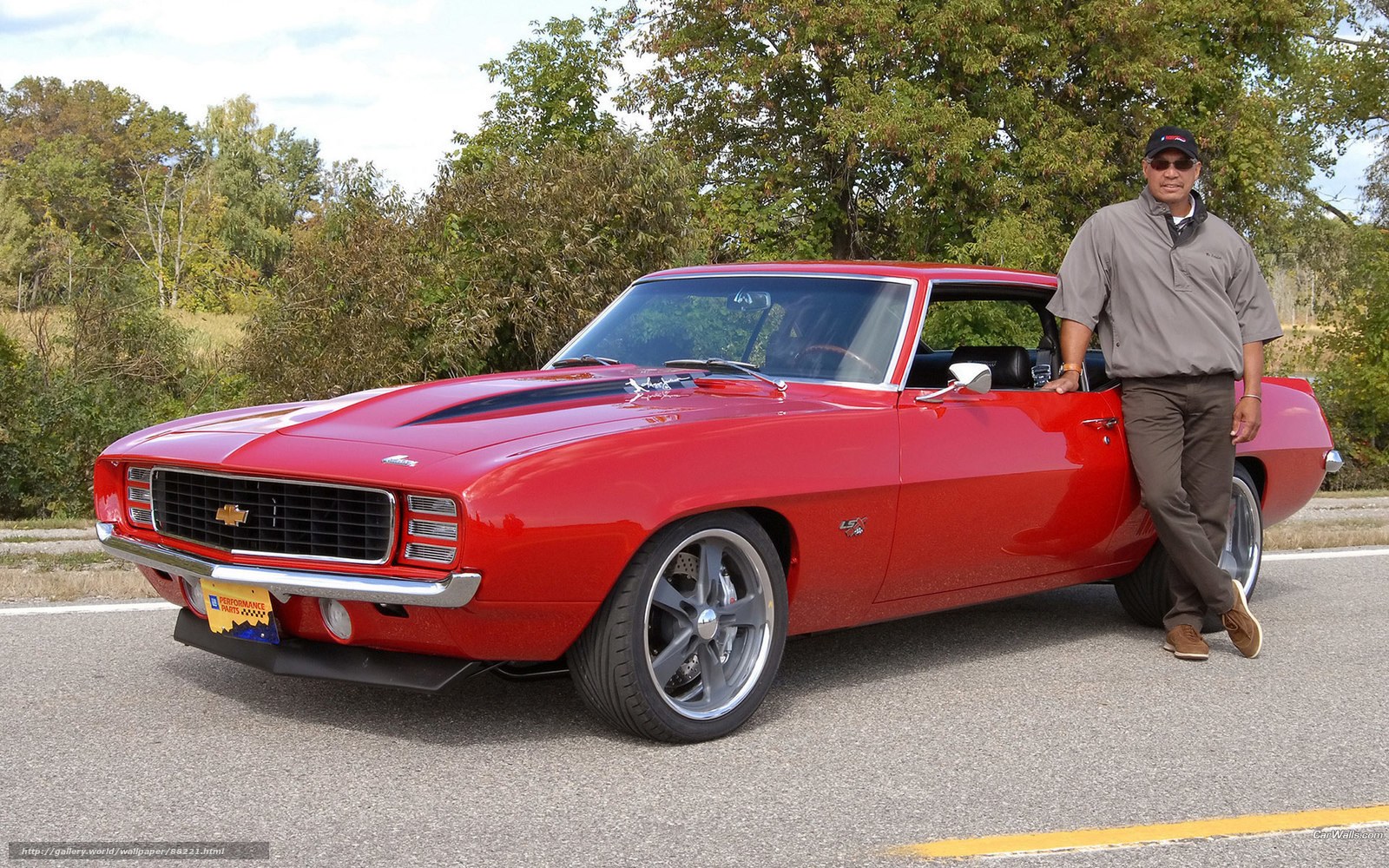 Man with red classic car