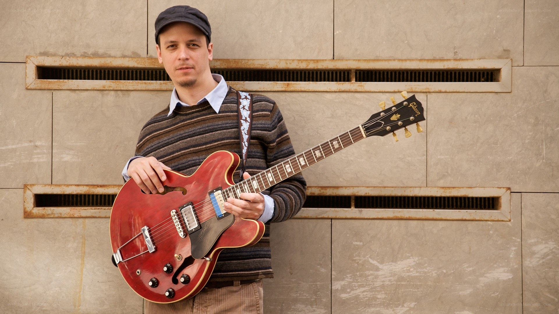 Man with red electric guitar