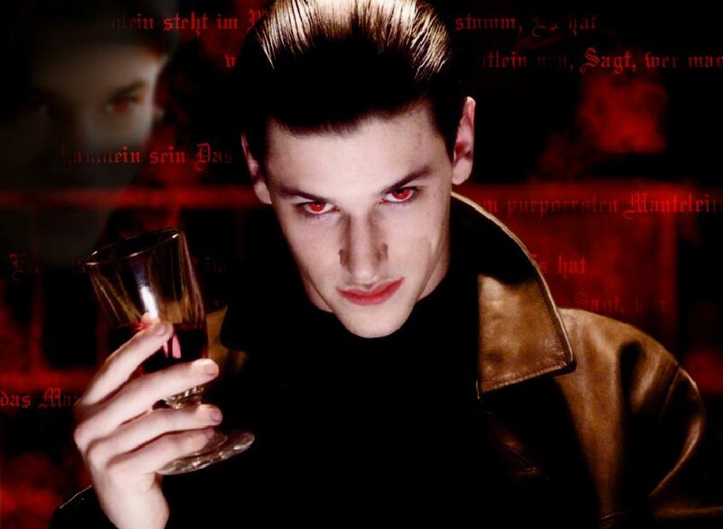 man with red eyes holding glass