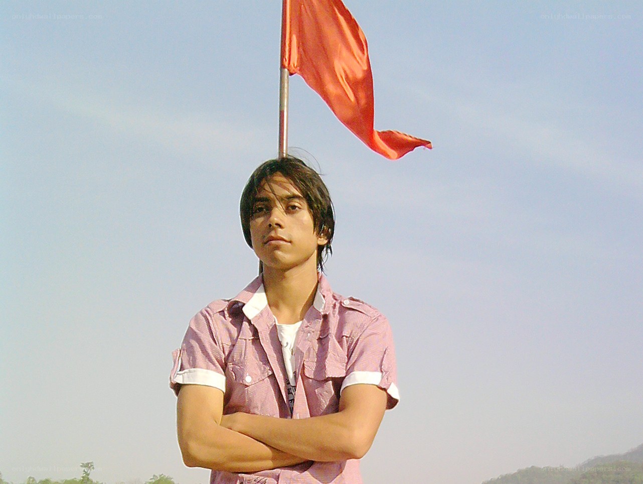 Man with red flag standing