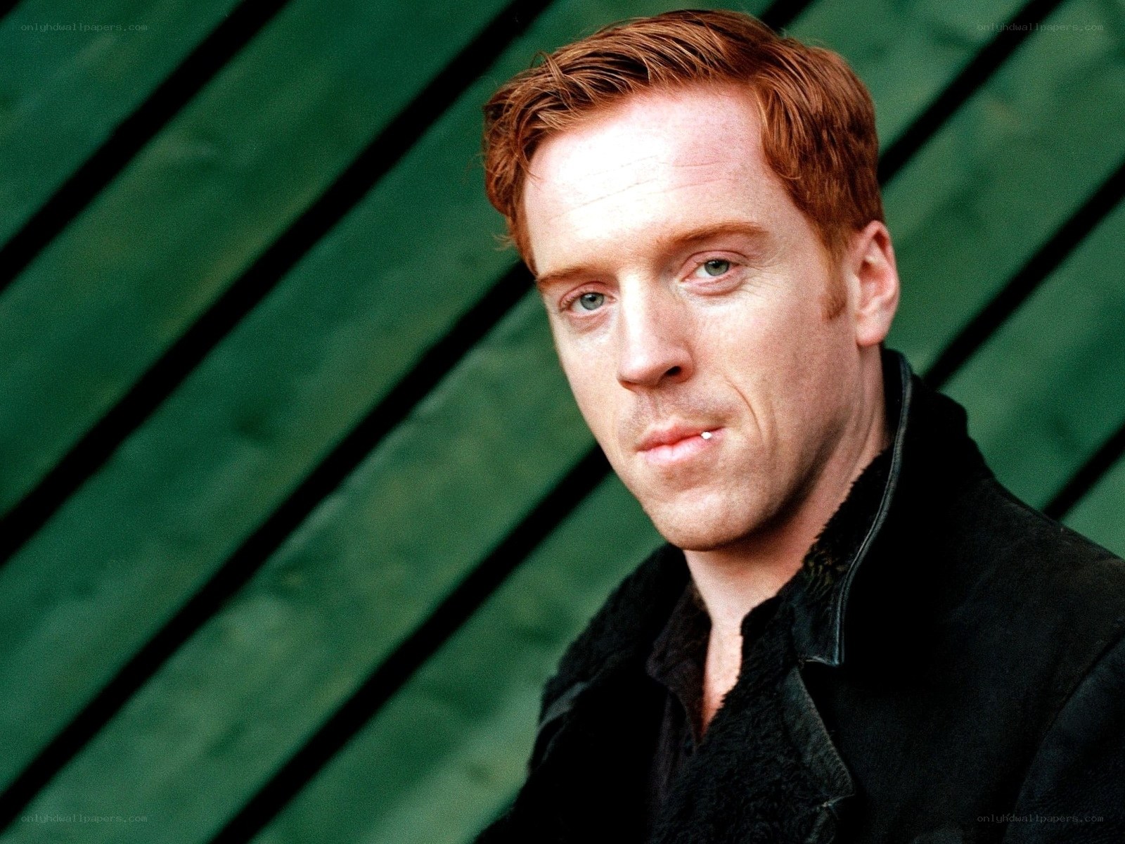 man with red hair in black jacket