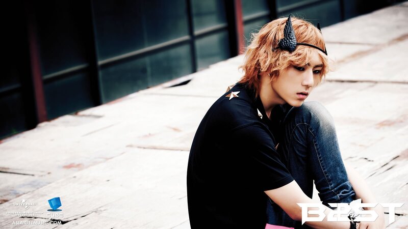 man with red hair sitting on steps