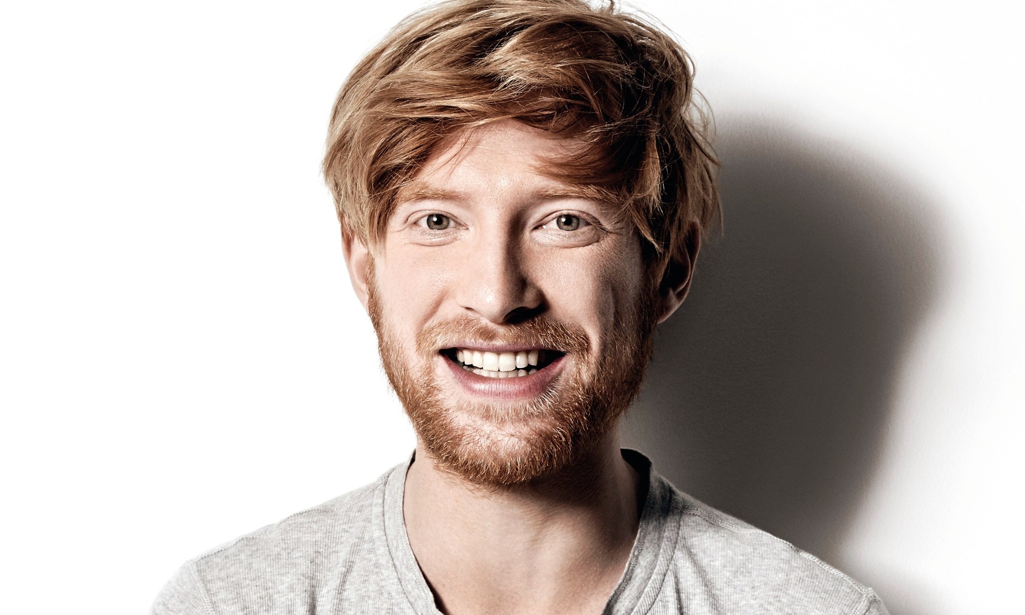 man with red hair smiling