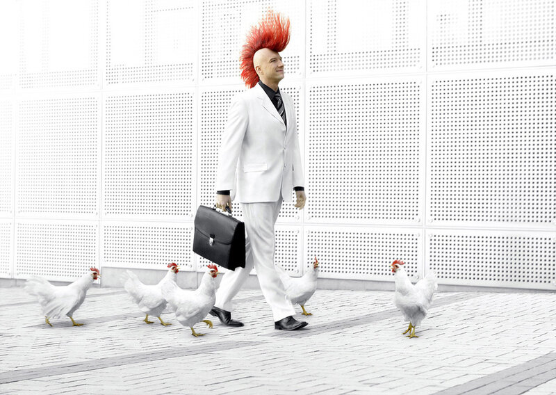 man with red mohawk and chickens